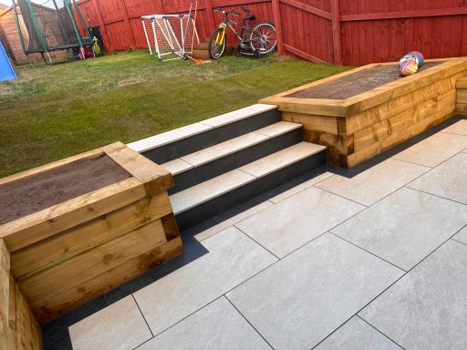 Garden Landscaping and Paving in Bradford Landscaped garden with grey paving, timber raised beds and steps in Leeds