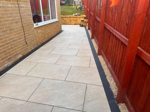 White Quartz Porcelain Paving – Bradford BD2 White quartz porcelain paving along the side of a house in Bradford BD2